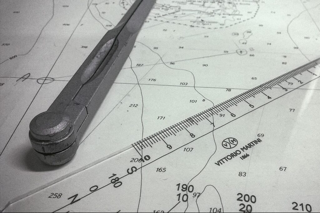 A picture of a sea map with navigation tools laid upon it