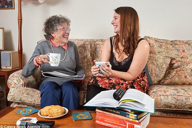 Elderly lady Florence enjoys a cup of tea on the sofa with Homeshare companion Alexandra