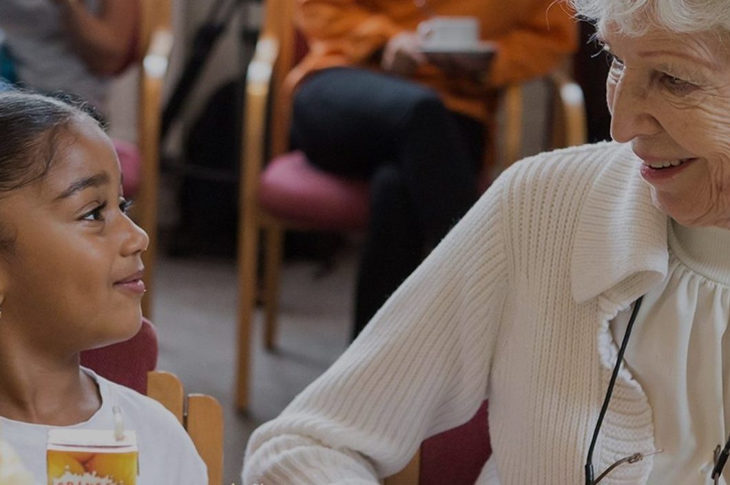 Young girl and older woman enjoying a conversation