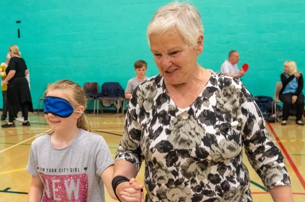 Grandaughter and grandmother playing games in sports hall