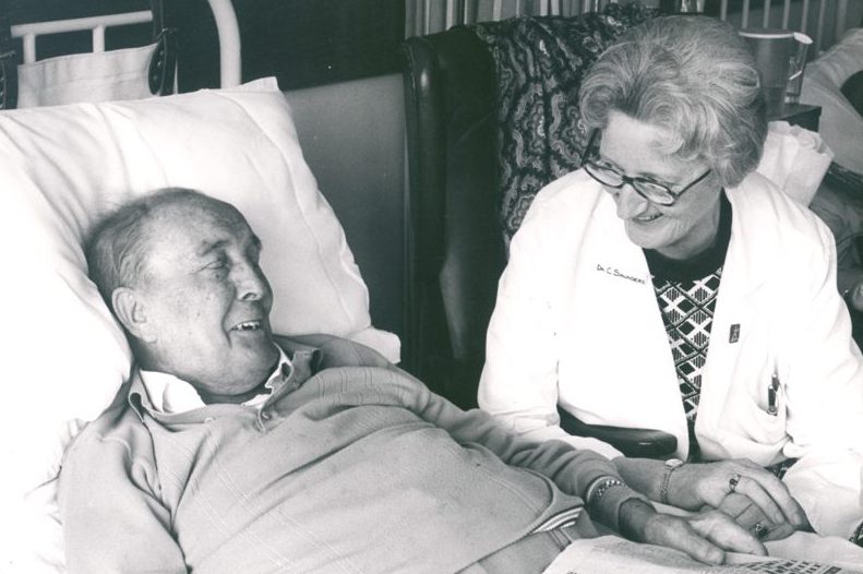 Dame Cicely Saunders at the bedside of a hospice resident.