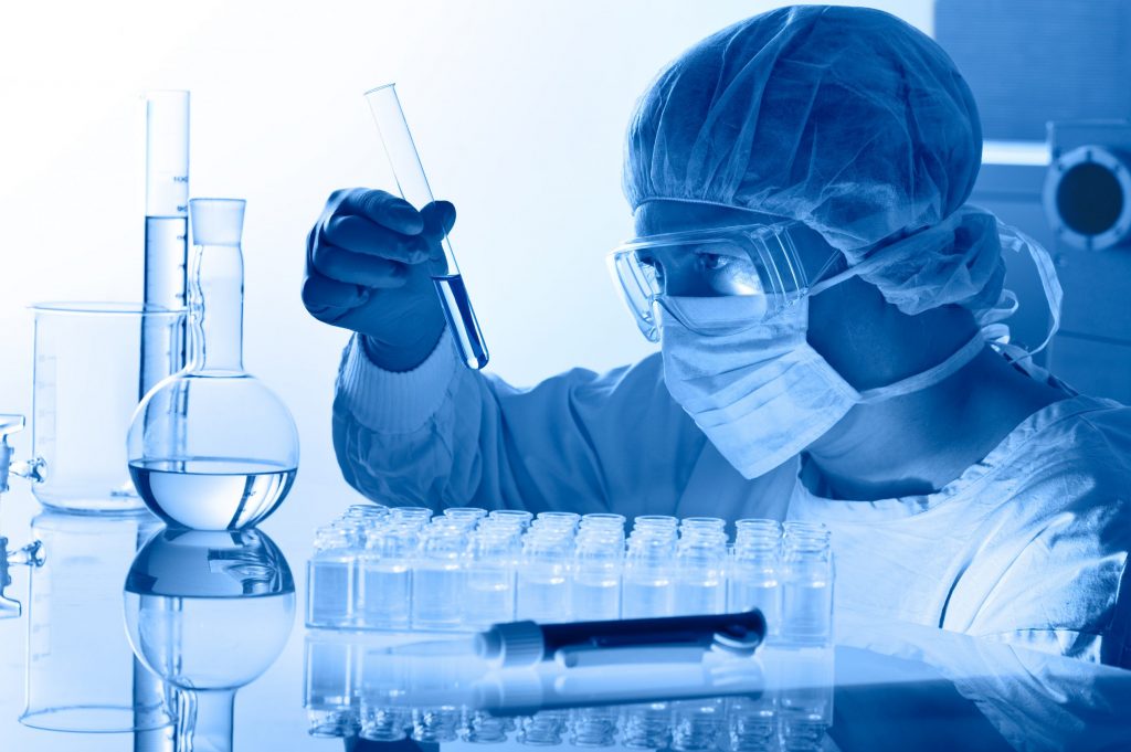 laboratory technician studying a test tube