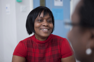 Social care manager smiling in conversation