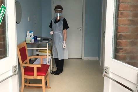Care home colleague ready to test visitors in a dedicated, covid-secure area.