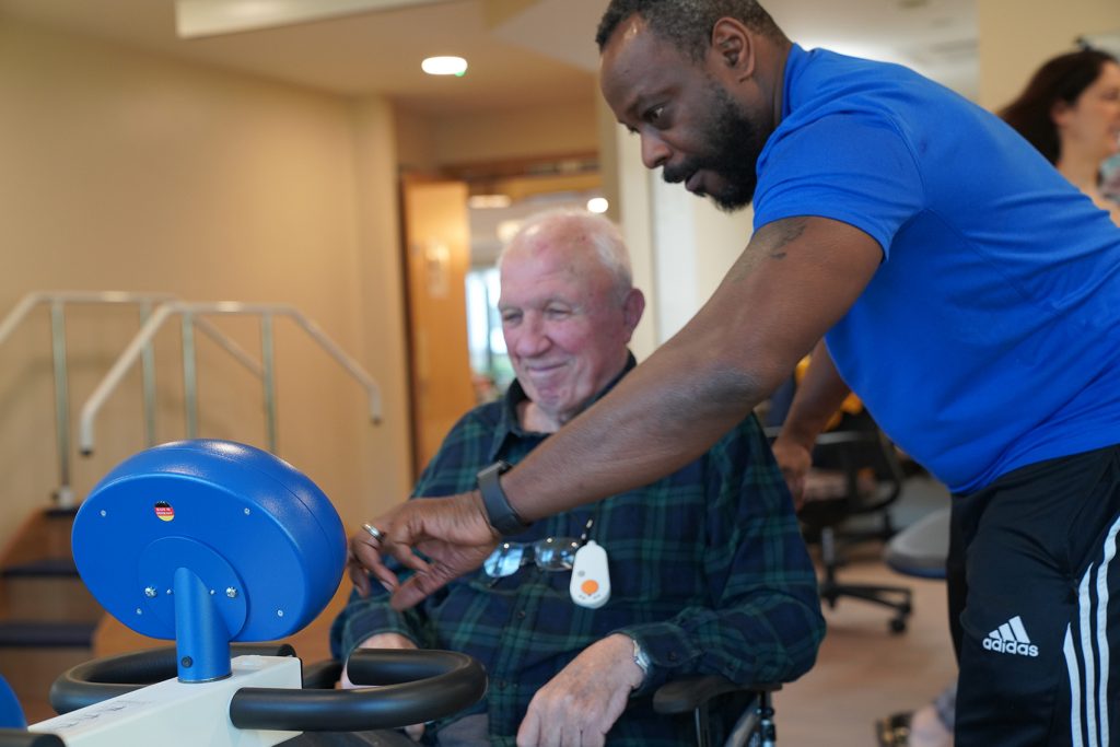 Louis and a resident at a time before pandemic restrictions kicked in