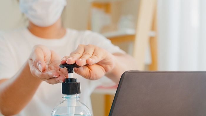 home care worker using sanitizer