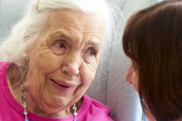 Care home resident talking to staff member