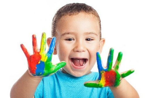 Happy kid with paint covered hands