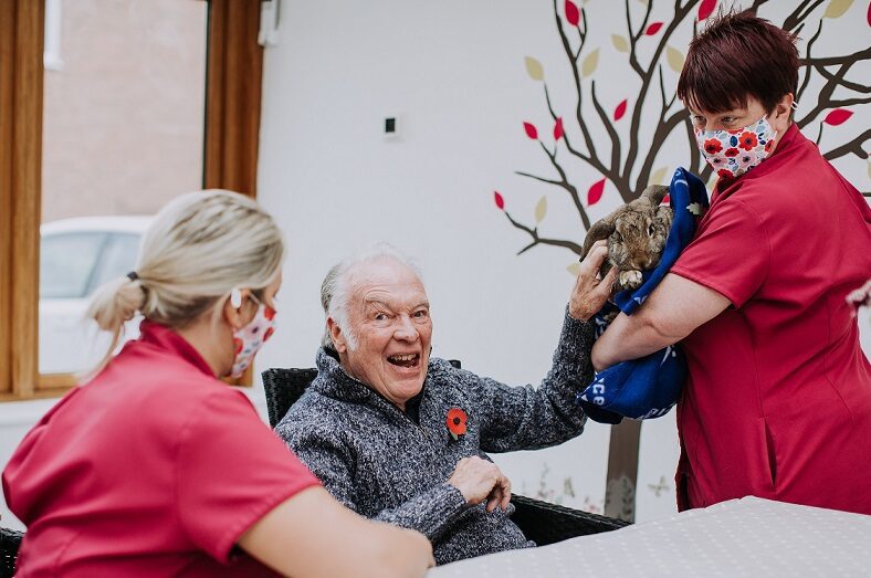 Residents and care staff with cat