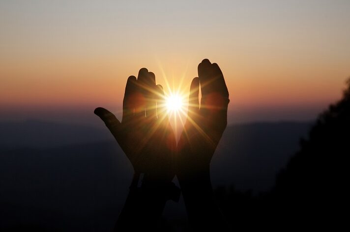 hands holding the sun