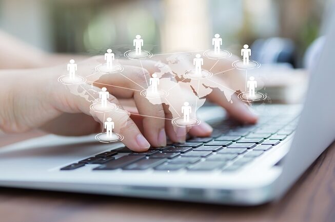 hand on keyboard with people icons overlaid
