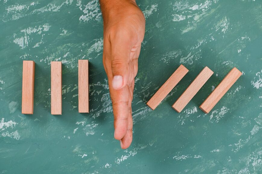 hand-as-barrier-dividing-wooden-blocks