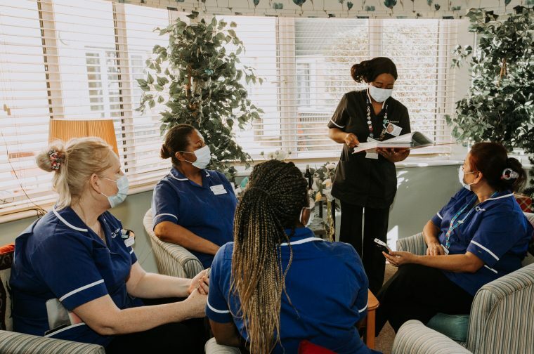 Ethnically diverse social care nurses having a team meeting