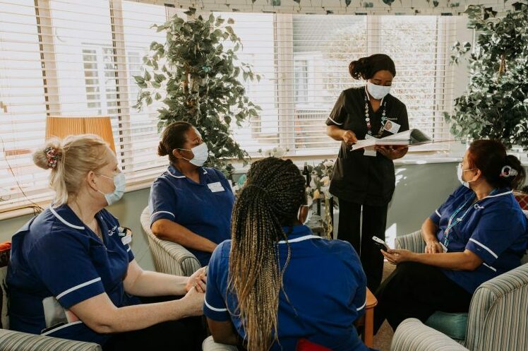 Ethnically diverse social care nurses having a team meeting