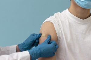 Plaster being put on a vaccinated shoulder