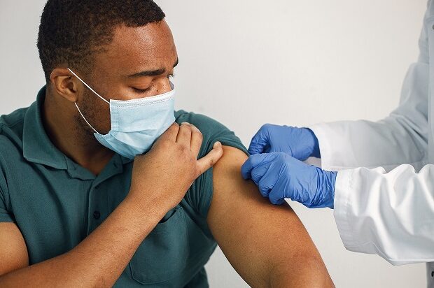 Man having his vaccination in the shoulder