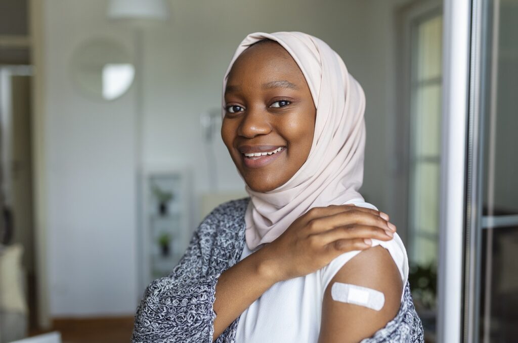 Smiling woman of colour, with plaster on arm