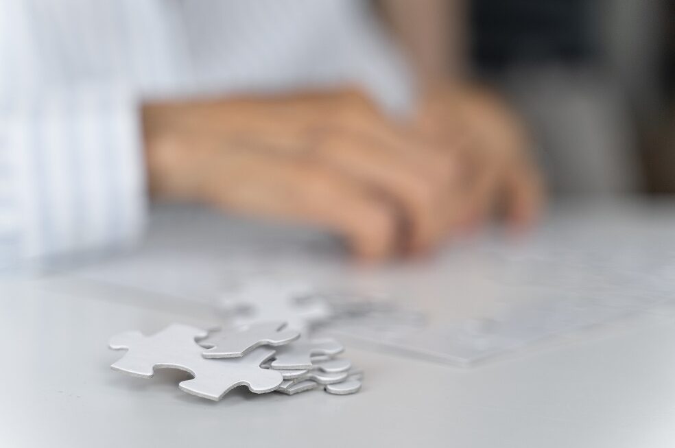 woman's hands doing a jigsaw