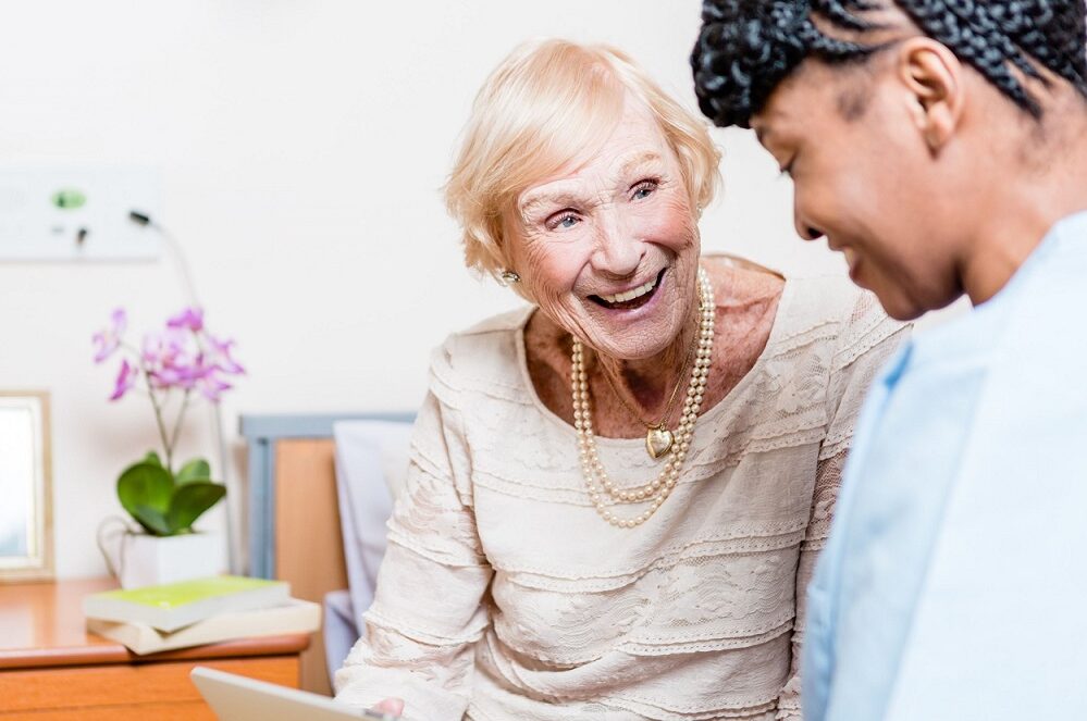 Happy care home resident with care colleague