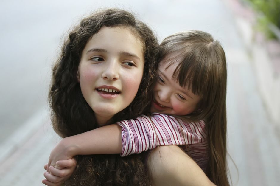 Young girl caring for her younger sister