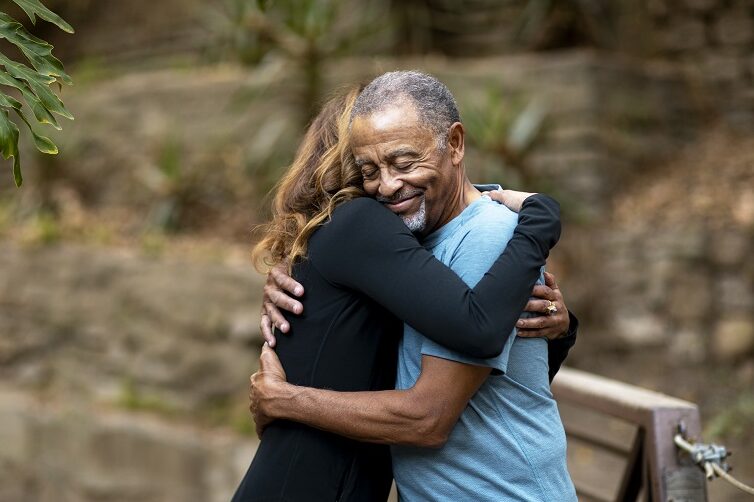 senior-people-hugging-outdoors-