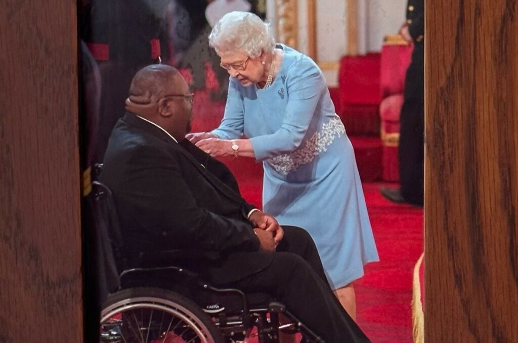 Clenton receiving his MBE from the Queen in 2014.