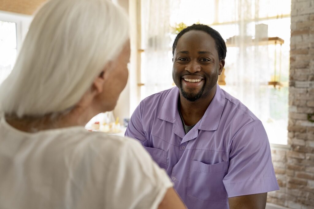 Care worker talking to older woman