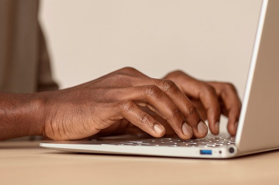 man typing on laptop