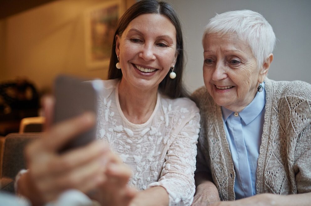 Woman and older woman looking at photos